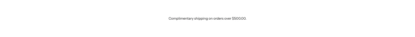 A centered line of text reading Complimentary shipping on orders over $500.00, where the amount is formatted by Liquid.